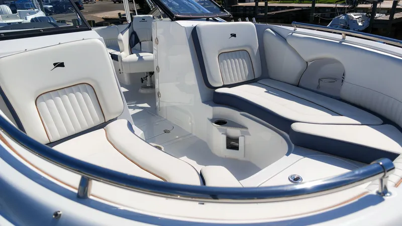 Slide: The Image of The image shows the cockpit of a Stingray 231 DC boat with white upholstery and blue accents. - 9