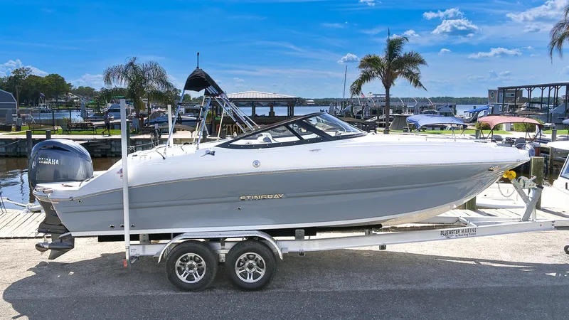 Slide: The Image of A modern 2027 Stingray 231 DC sits on a trailer in a marina. - 24