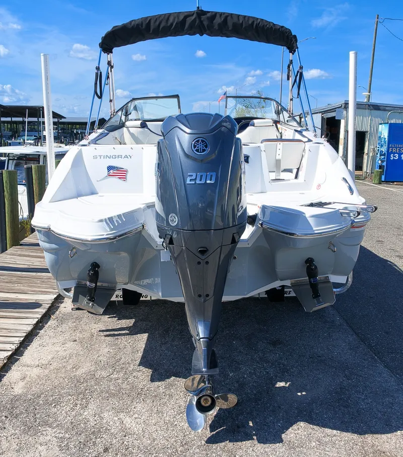 Slide: The Image of The image shows a 2027 Stingray 231 DC boat with an outboard motor. - 3