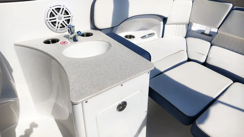 Slide: The Image of The image shows the cockpit of a Stingray 231 DC boat with a sink and seating area. - 11