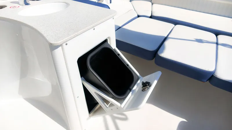 Slide: The Image of The image shows the interior of a Stingray 231 DC boat with a built-in trash bin. - 12