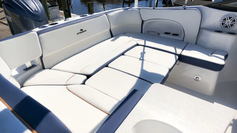 Slide: The Image of The image shows the spacious cockpit of a Stingray 231 DC boat with comfortable white seating. - 6
