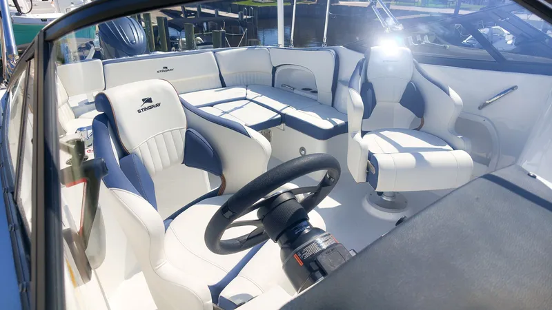 Slide: The Image of The image shows the cockpit of a 2027 Stingray 231 DC boat with white and blue seats. - 7
