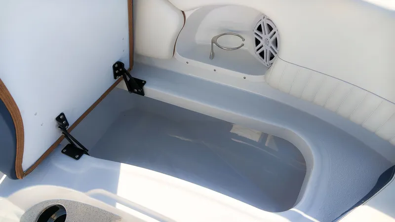 Slide: The Image of Interior of a Stingray 231 DC boat with white upholstery and a speaker. - 20