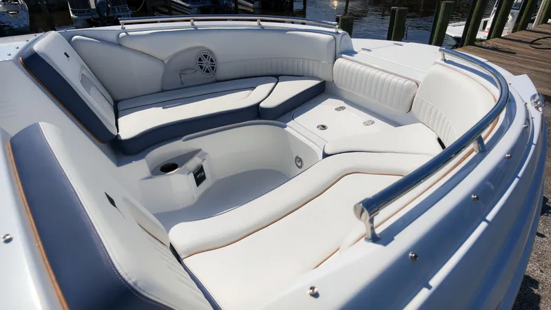 Slide: The Image of The image shows the cockpit of a Stingray 231 DC boat with sleek white and blue upholstery. - 8