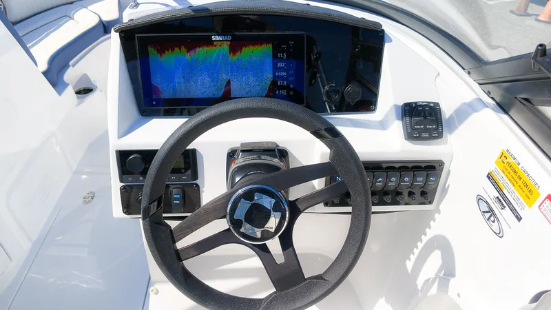 Slide: The Image of The image shows the helm of a Stingray 231 DC boat with a modern display and controls. - 23