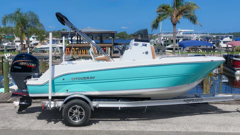 Slide: The Image of A turquoise 2027 Stingray 173 CC on a trailer in a marina setting. - 16
