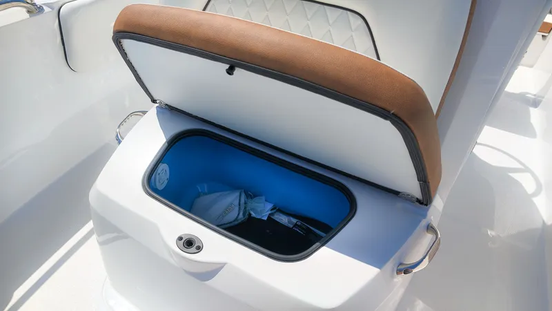Slide: The Image of An open storage compartment on a boat with brown upholstery and blue interior lining. - 13