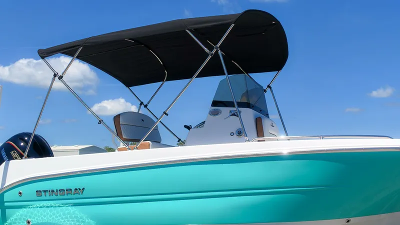 The Image of A turquoise 2027 Stingray 173 CC with a black sunshade and modern helm station. - 1
