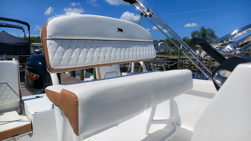 Slide: The Image of The image shows white upholstery on a boat seat with brown accents under a blue sky. - 11