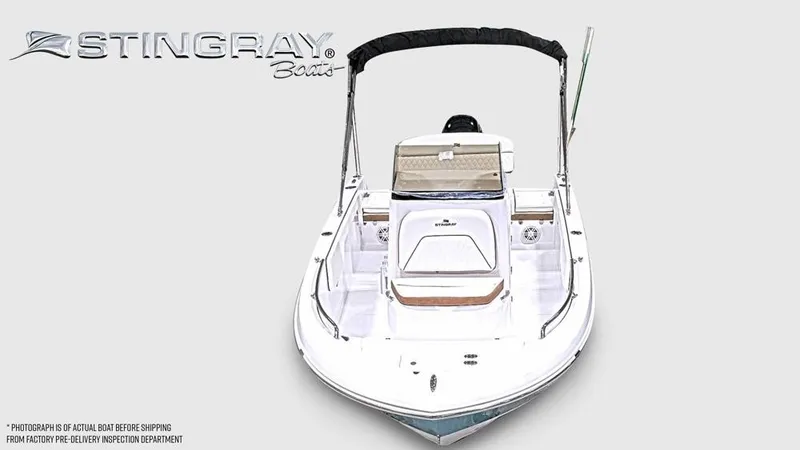 Slide: The Image of A white Stingray 173 CC boat with a bimini top and seating, photographed from the front. - 6