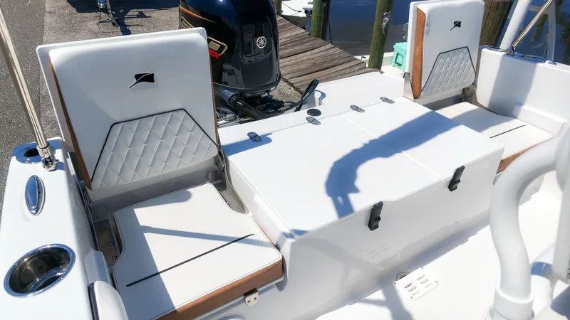 Slide: The Image of The image shows the cockpit of a 2027 Stingray 173 CC boat with white seats and an outboard motor. - 7