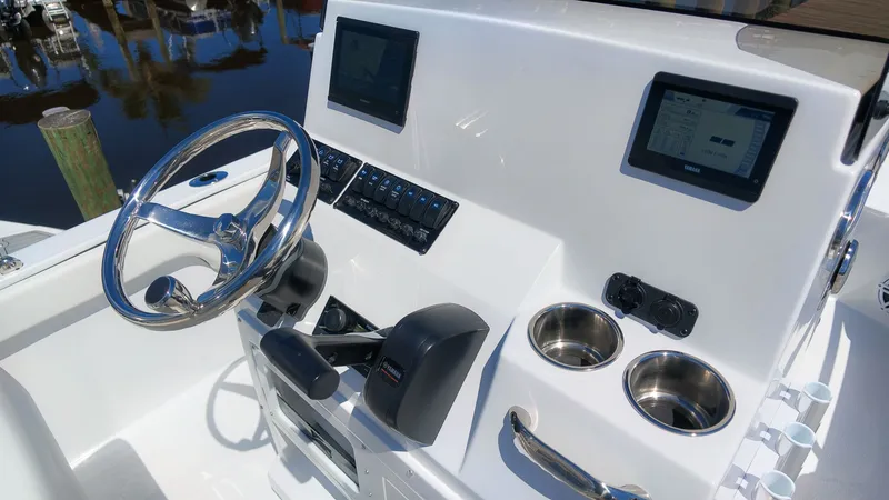 Slide: The Image of The image shows a boat's helm with a shiny steering wheel and two screens. - 10