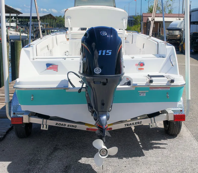 Slide: The Image of The image shows a 2027 Stingray 173 CC boat on a trailer. It features a 115 HP outboard motor and an American flag. - 3
