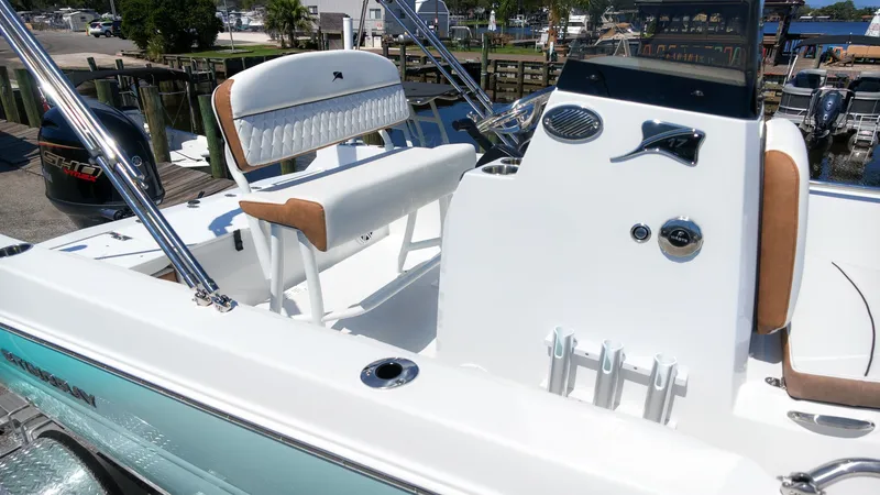 Slide: The Image of The image shows the cockpit of a 2027 Stingray 173 CC boat with white and brown interior. - 4