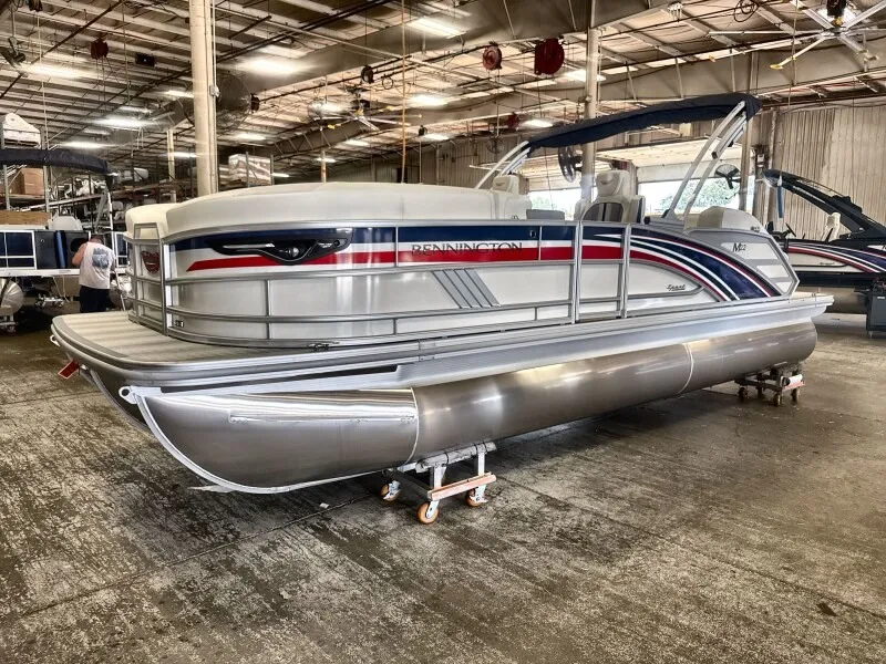 Slide: The Image of A 2027 Bennington 22 M Swingback pontoon boat is in a warehouse. It features a modern design. - 3