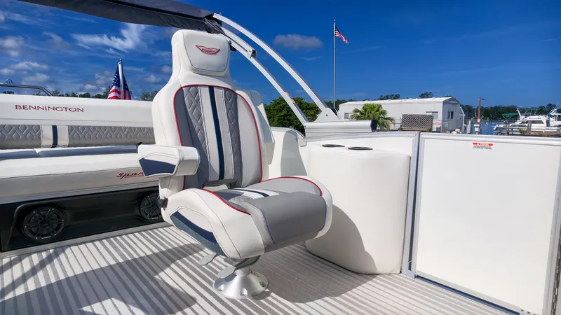 Slide: The Image of A luxurious captain's chair on a Bennington 22 M Swingback pontoon boat, surrounded by sleek details. - 11