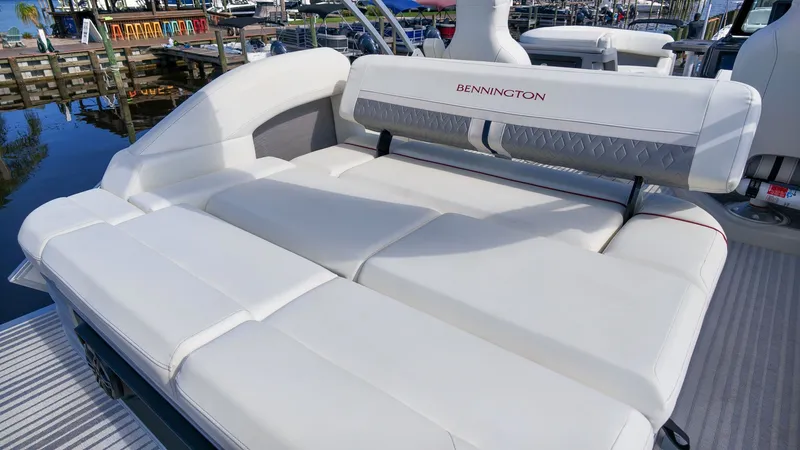 Slide: The Image of The image shows the luxurious white upholstery of the 2027 Bennington 22 M Swingback. - 7