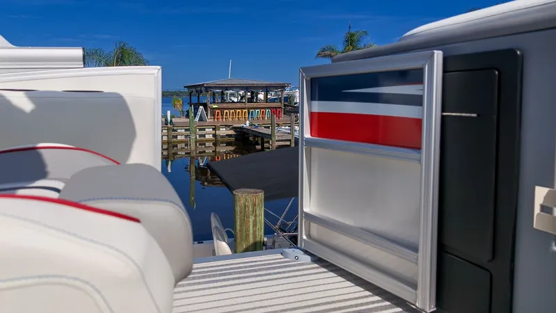 Slide: The Image of A modern boat with sleek seating and colorful design at the dock. - 12
