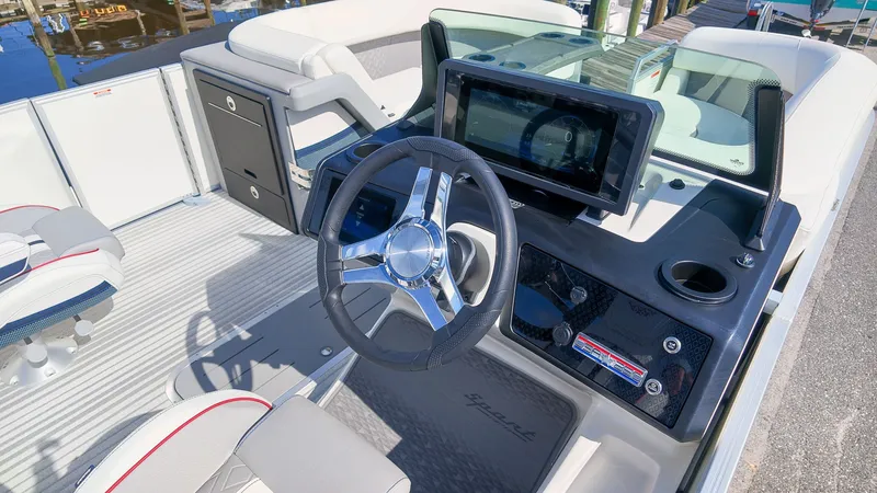 Slide: The Image of The image shows the cockpit of a 2027 Bennington 22 M Swingback with a modern helm. - 24