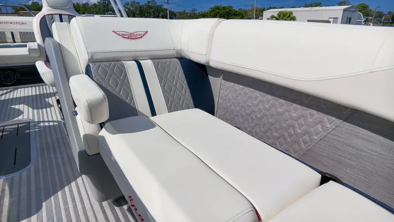 Slide: The Image of The Bennington 22 M Swingback features luxurious white seating, offering comfort and style on the water. - 19