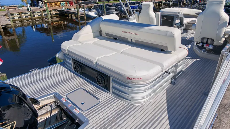 Slide: The Image of The image shows a 2027 Bennington 22 M Swingback pontoon boat with sleek white seating. - 6