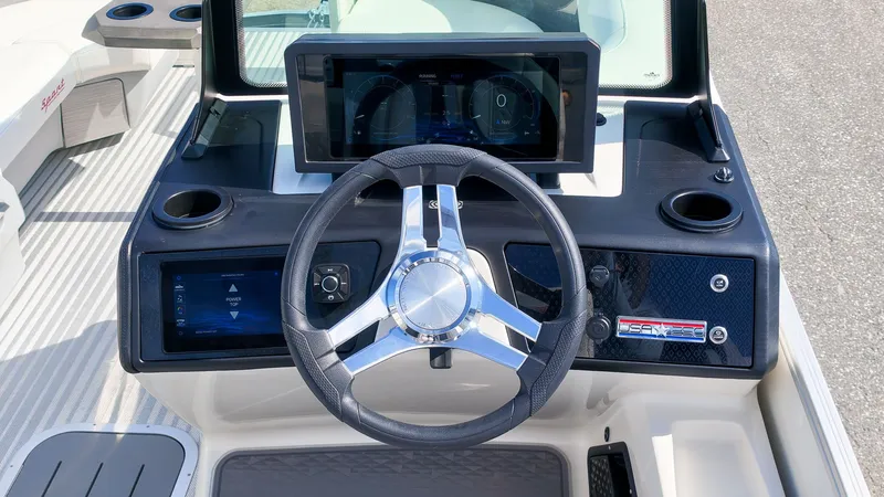 Slide: The Image of The image shows the helm of a Bennington 22 M Swingback boat with a modern display. - 23
