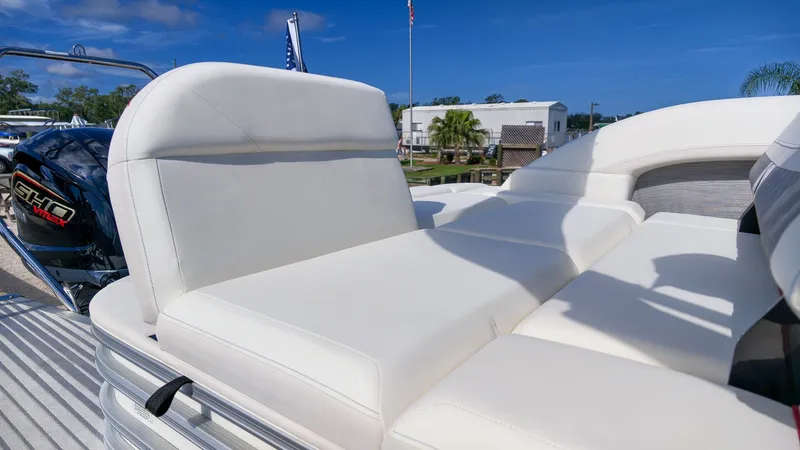 Slide: The Image of The image shows the luxurious white upholstery of a 2027 Bennington 22 M Swingback. - 8