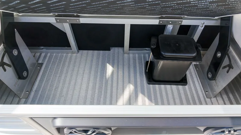 Slide: The Image of Interior view of a boat storage compartment with metal framing and a black container. - 10