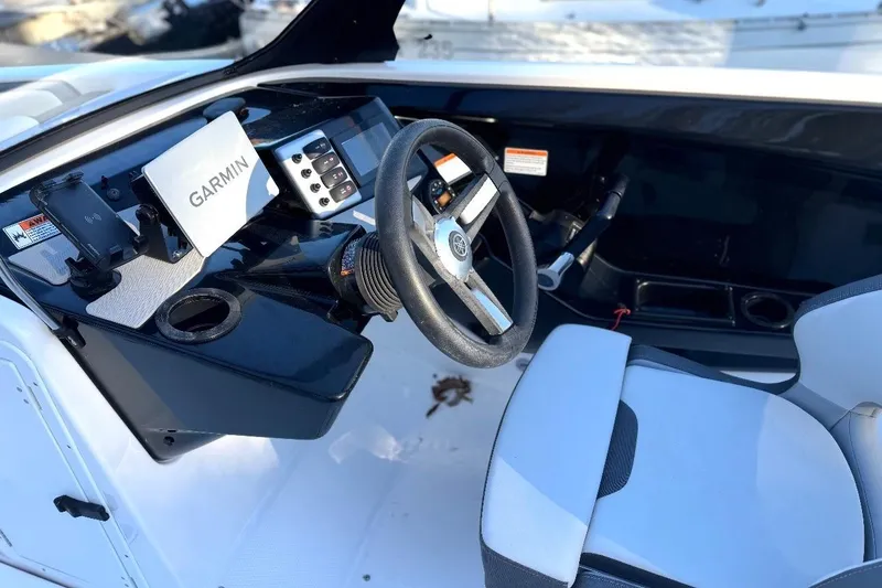 Slide: The Image of 2023 Yamaha Boats SX220 cockpit with Garmin navigation system and sleek steering wheel. - 7
