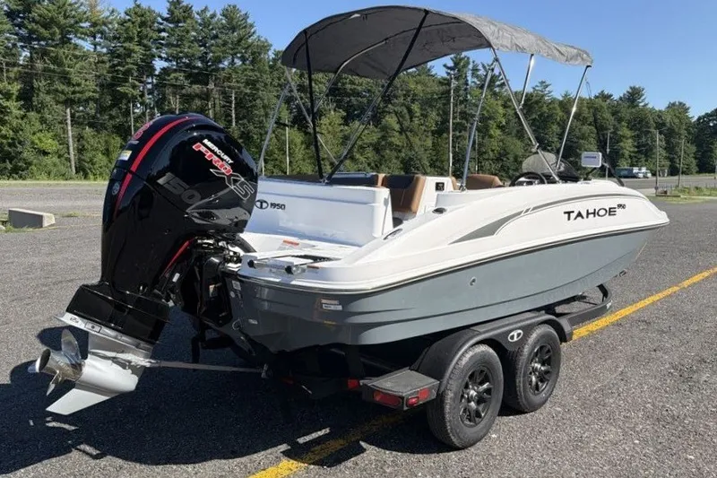 Slide: The Image of 2026 Tahoe 1950 boat on trailer with canopy and powerful outboard motor. - 4