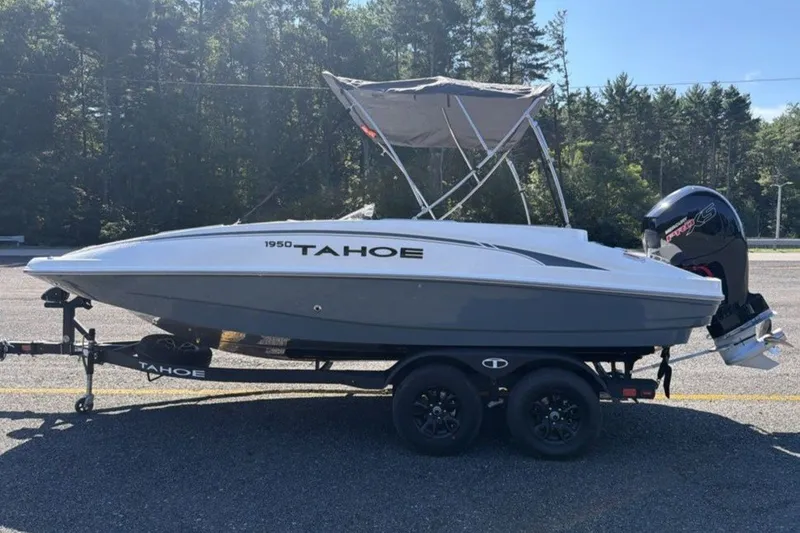 Slide: The Image of 2026 Tahoe 1950 boat on trailer, parked outdoors with forest background. - 3