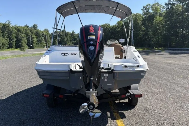Slide: The Image of 2026 Tahoe 1950 boat with outboard motor on trailer, parked in sunny outdoor setting. - 11