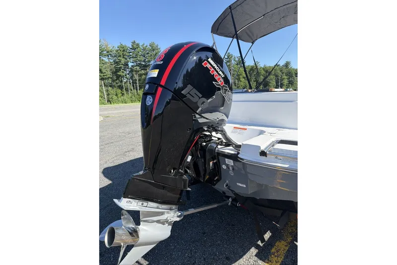 Slide: The Image of Boat with Mercury Pro 150 outboard motor, Tahoe 1950 model, 2026, parked outdoors. - 12