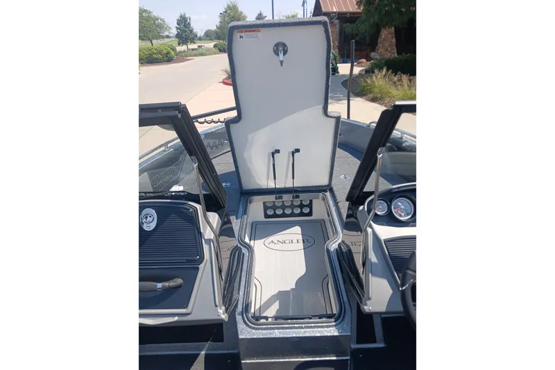 Slide: The Image of 2026 Ranger 1880MS boat interior with open storage compartment and control panel. - 3