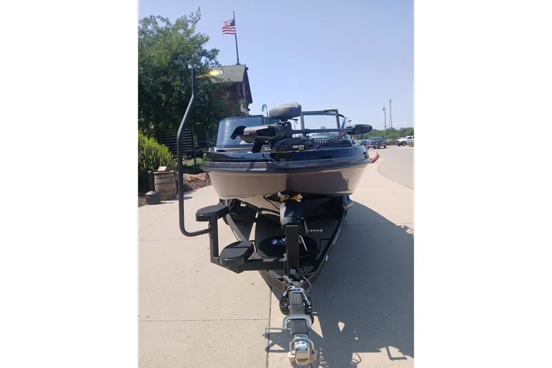 Slide: The Image of 2026 Ranger 1880MS boat on trailer, parked outdoors with American flag in background. - 1