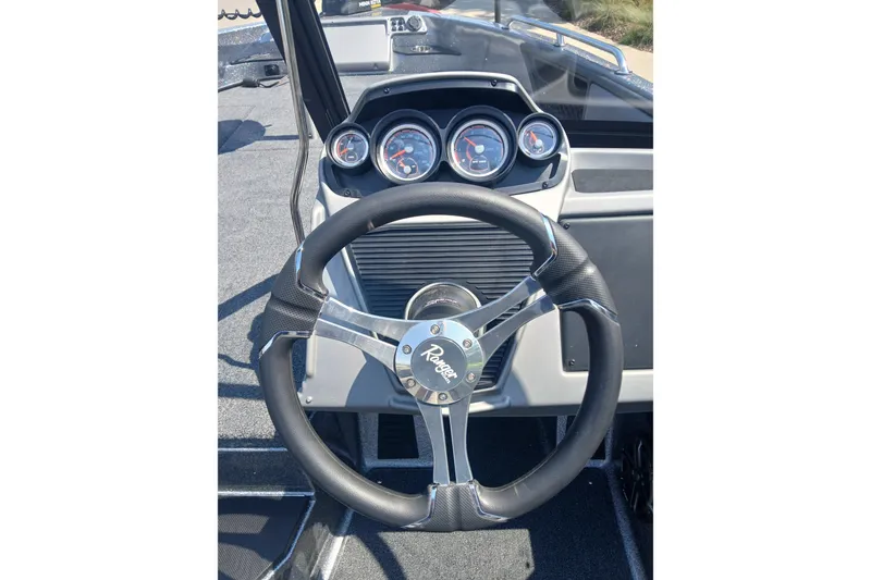 Slide: The Image of Steering wheel and dashboard of 2026 Ranger 1880MS boat, featuring modern gauges. - 5