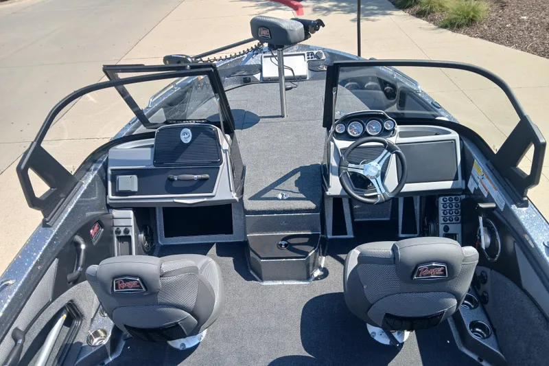Slide: The Image of 2026 Ranger 1880MS boat interior with steering wheel, dashboard, and seating. - 2