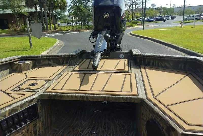 Slide: The Image of 2026 Tracker Grizzly 1650 T Prairie Wings Edition boat interior with camo design and motor. - 3