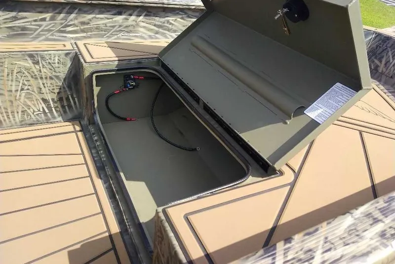 Slide: The Image of Open storage compartment in 2026 Tracker Grizzly 1650 T Prairie Wings Edition boat. - 4