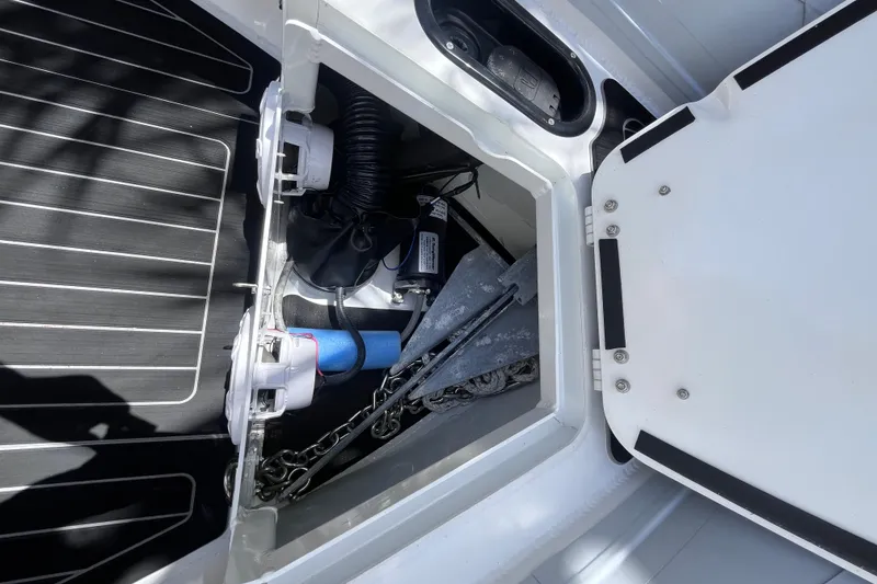 Slide: The Image of Open storage compartment on 2024 Highfield Sport 520 boat, showing anchor and equipment. - 16