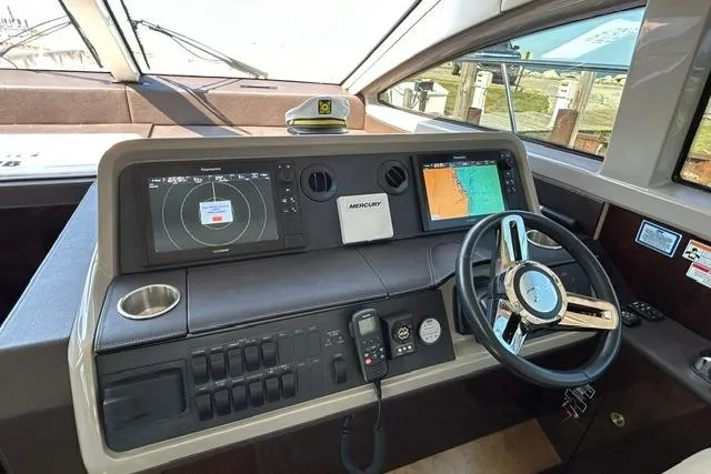 Slide: The Image of Helm of 2017 Sea Ray Sundancer 400 with navigation screens and steering wheel. - 39
