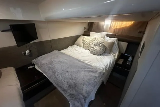 Slide: The Image of Luxurious cabin interior of 2017 Sea Ray Sundancer 400 yacht with cozy bedding and TV. - 20