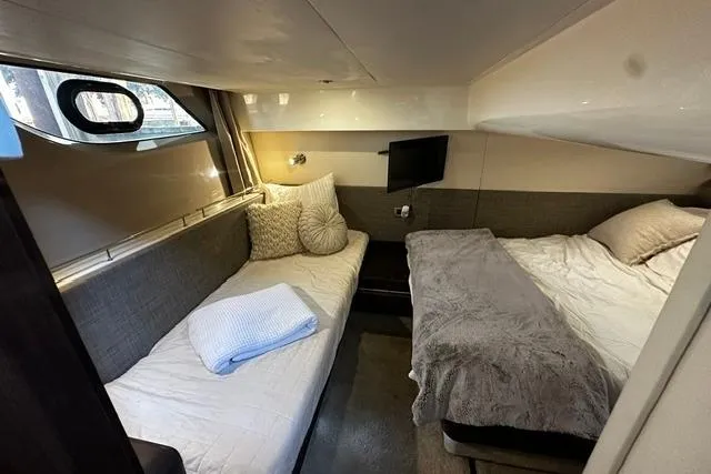Slide: The Image of Interior cabin of 2017 Sea Ray Sundancer 400 with cozy twin beds and modern decor. - 22