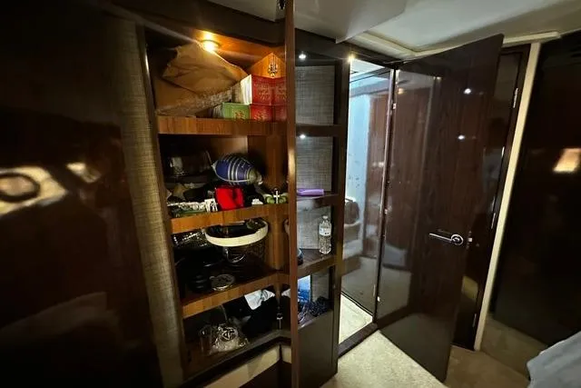 Slide: The Image of Interior of 2017 Sea Ray Sundancer 400 yacht with open storage shelves and door. - 28