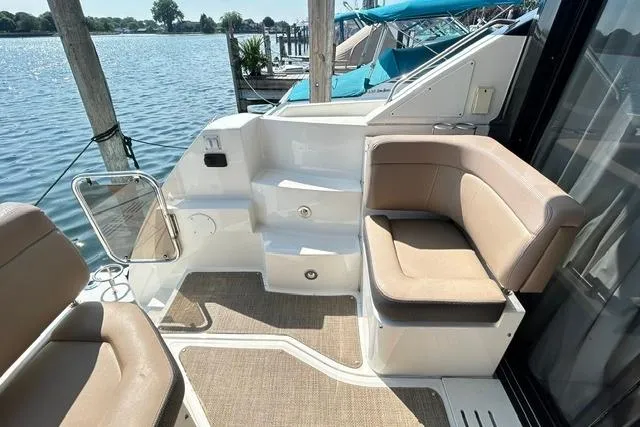 Slide: The Image of 2017 Sea Ray Sundancer 400 yacht deck with beige seating and water view. - 11