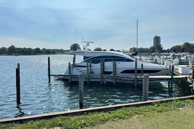 Slide: The Image of 2017 Sea Ray Sundancer 400 yacht docked at a serene marina. - 6