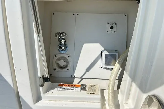 Slide: The Image of Control panel on a 2017 Sea Ray Sundancer 400 yacht, featuring valves and warning labels. - 30