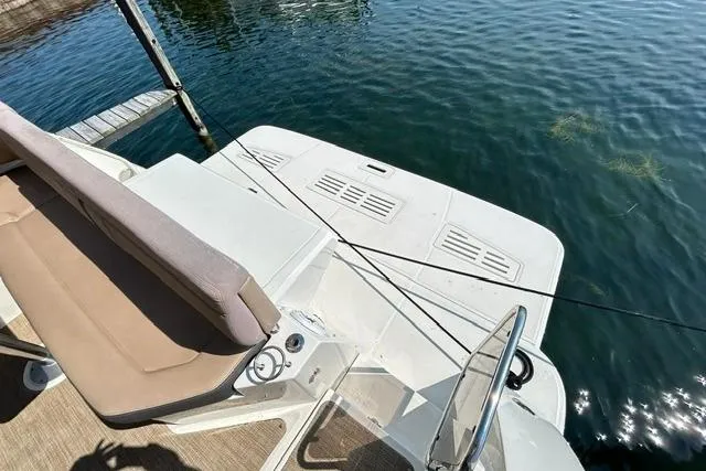 Slide: The Image of 2017 Sea Ray Sundancer 400 boat deck with seating, docked on calm water. - 7