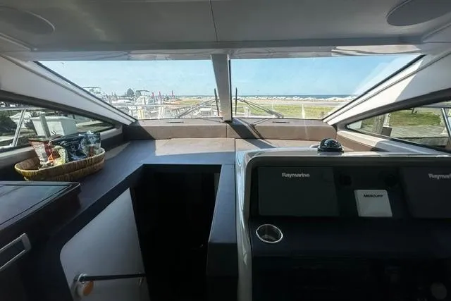Slide: The Image of 2017 Sea Ray Sundancer 400 helm with panoramic windows and modern navigation equipment. - 19